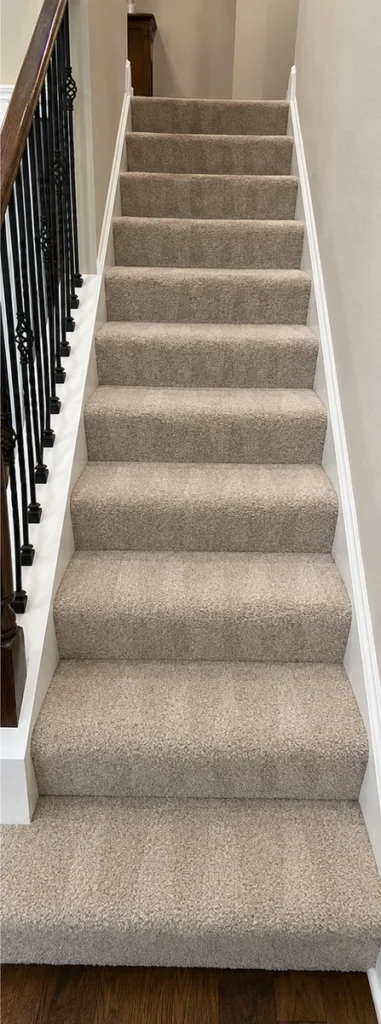 Carpeted staircase with a cleaner, more even appearance after cleaning
